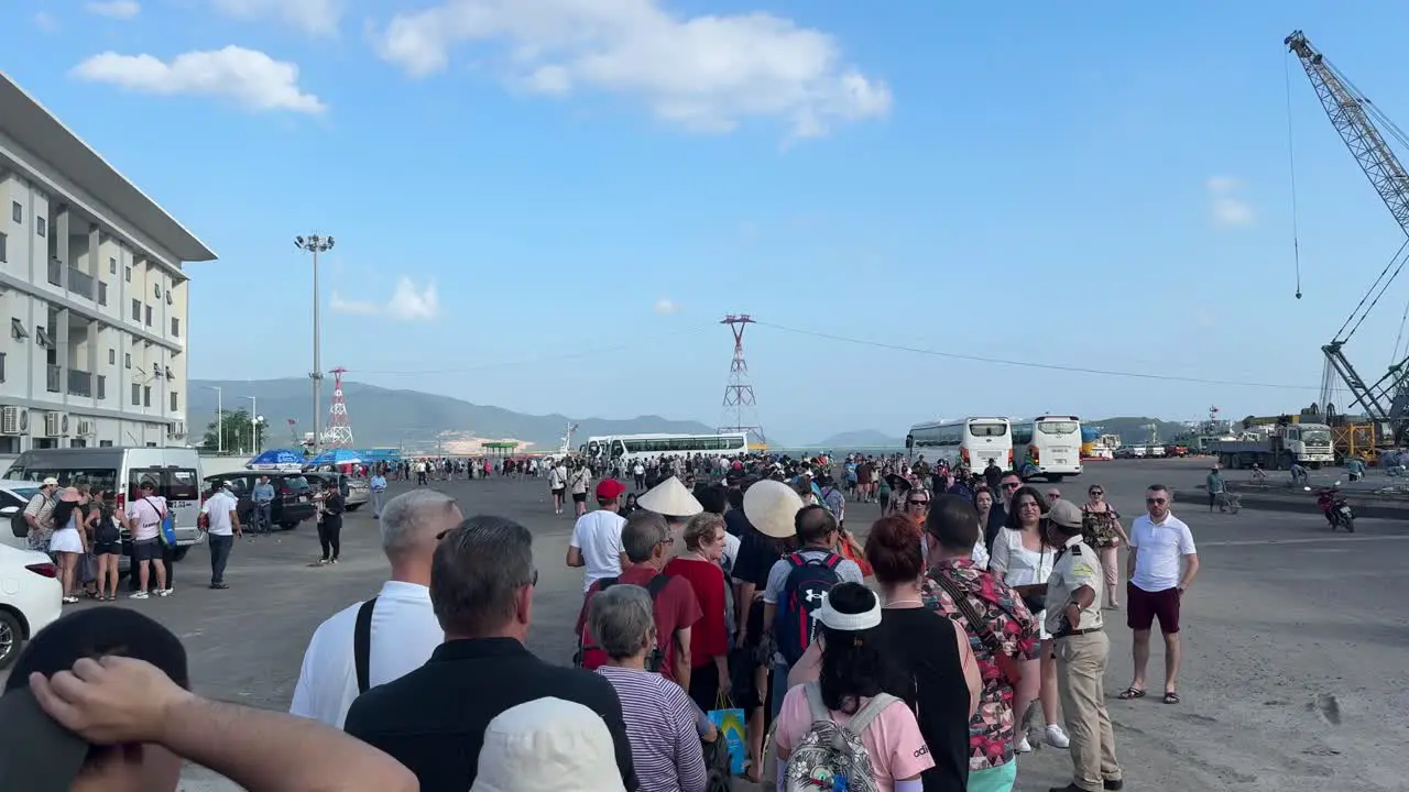 Scene of long waiting lines and cruise passengers queuing to take the tender boat back to Cruise in Nha Trang Vietnam