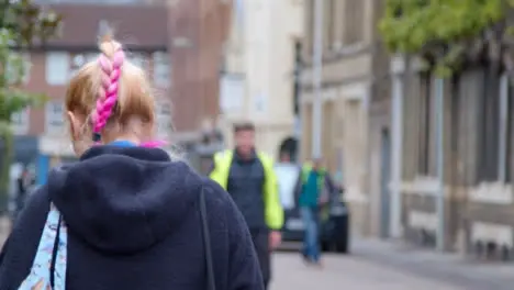 Tracking Shot Following Person with Pink Hair In Street