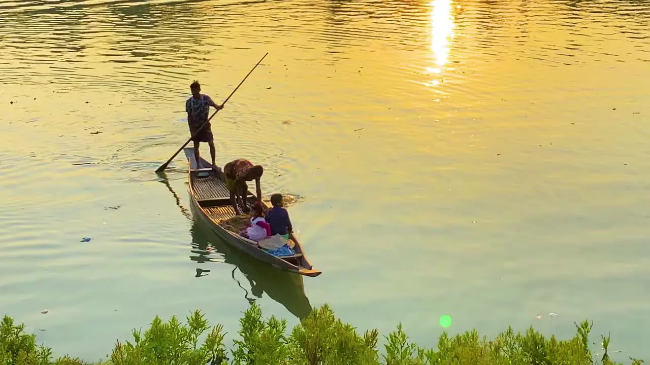 Fisherman dropping fishing net in river by boat at morning sunlight at Surma river in Sylhet Bangladesh