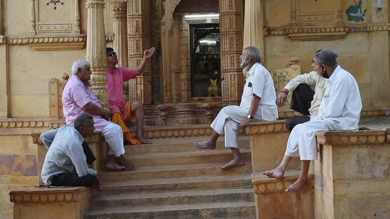 Elderly friends talking and chilling outside lord shiva temple