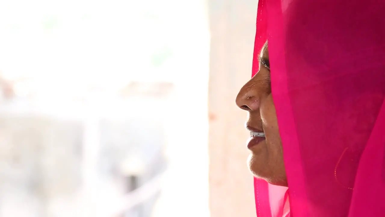 Profile of authentic Indian woman with fuchsia sari