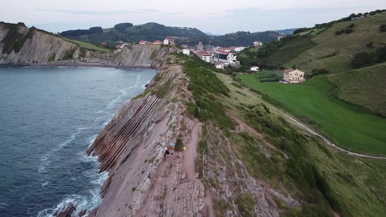 Couple alone embracing each other on the cliffs of northern Spain Zumaia