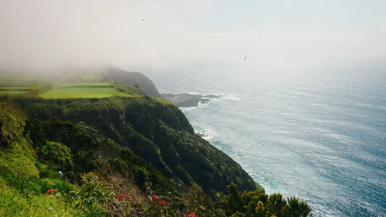 Slow motion wide shot of rocky coastline from high viewpoint