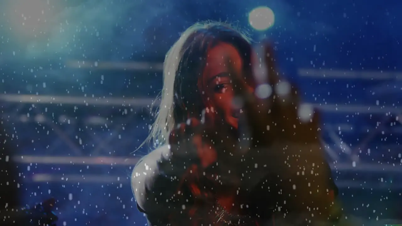 Animation of snow falling over caucasian woman singing