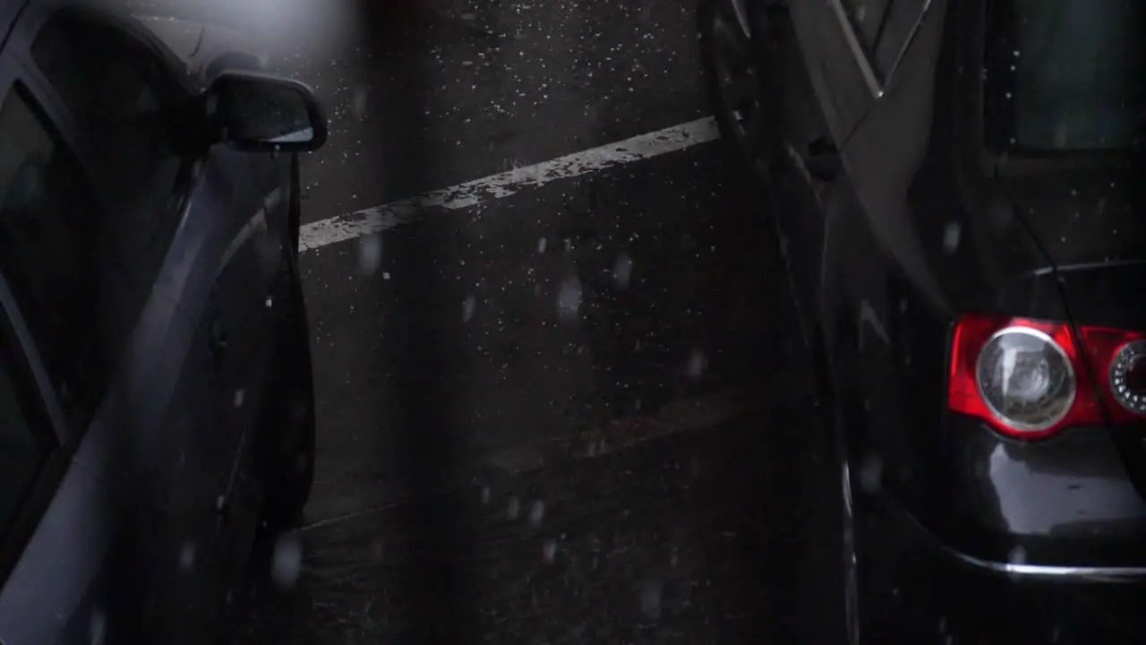 Hail stones splashing on the road between parking cars in 180 fps slow motion