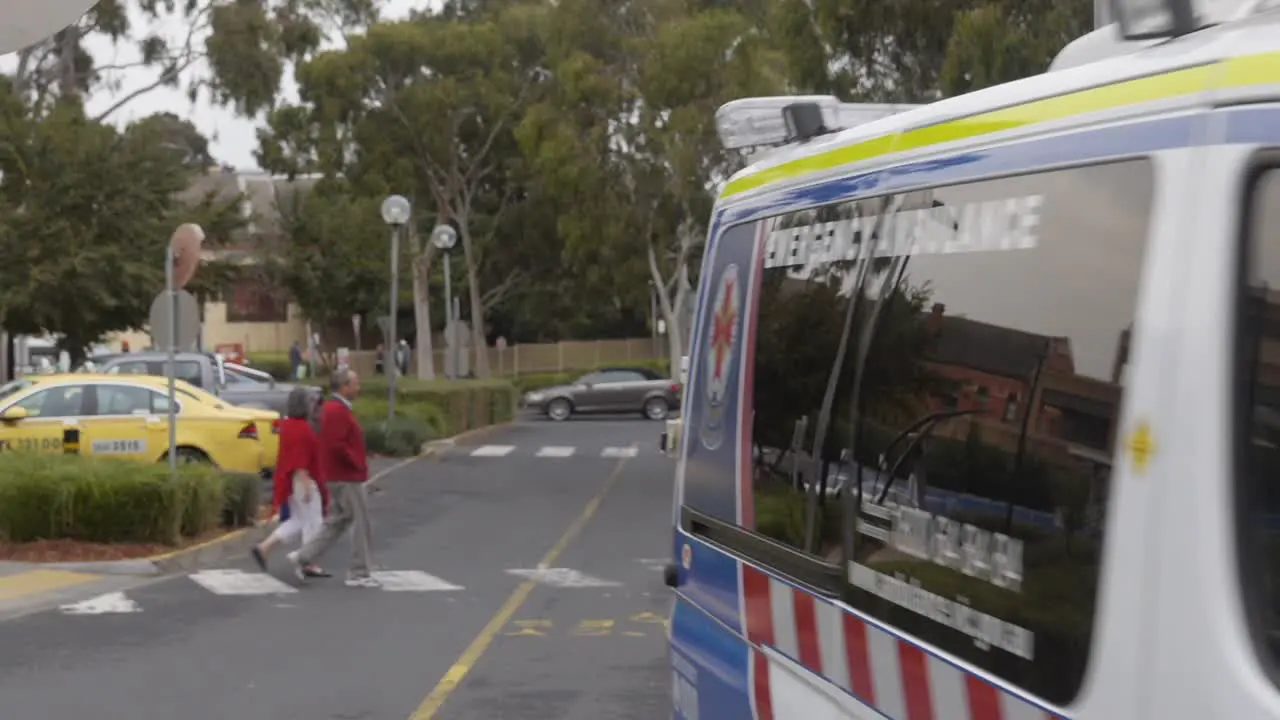 Ambulance at hospital drives past around hospital premises