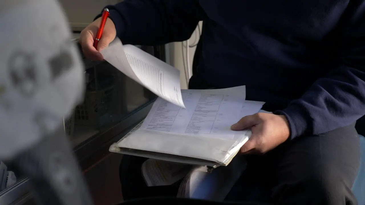 Emergency medical technician prepares paperwork inside an ambulance to be ready for emergency response