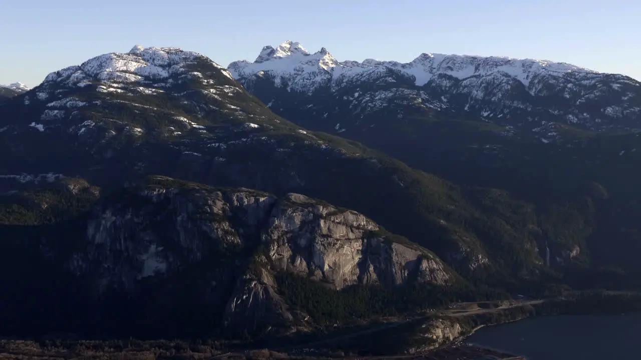 Beautiful snow capped green rock mountains of Canada -aerial