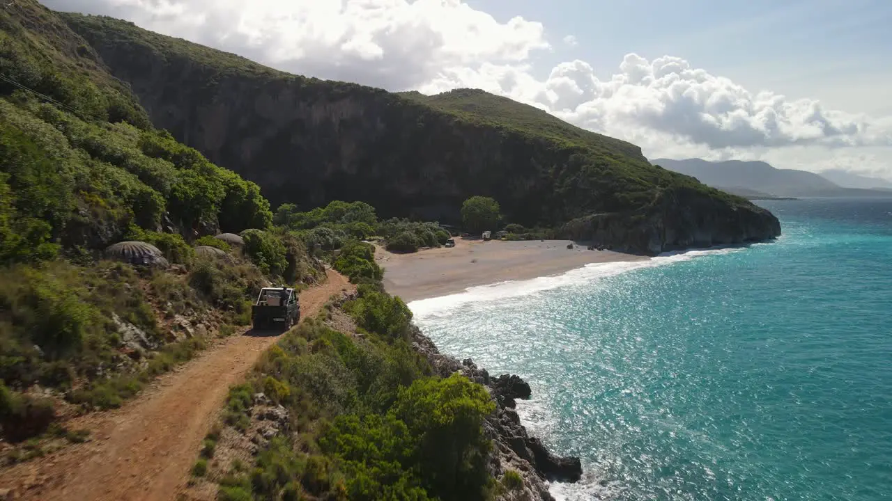 Car driving along coast road Gjipe Beach Albania