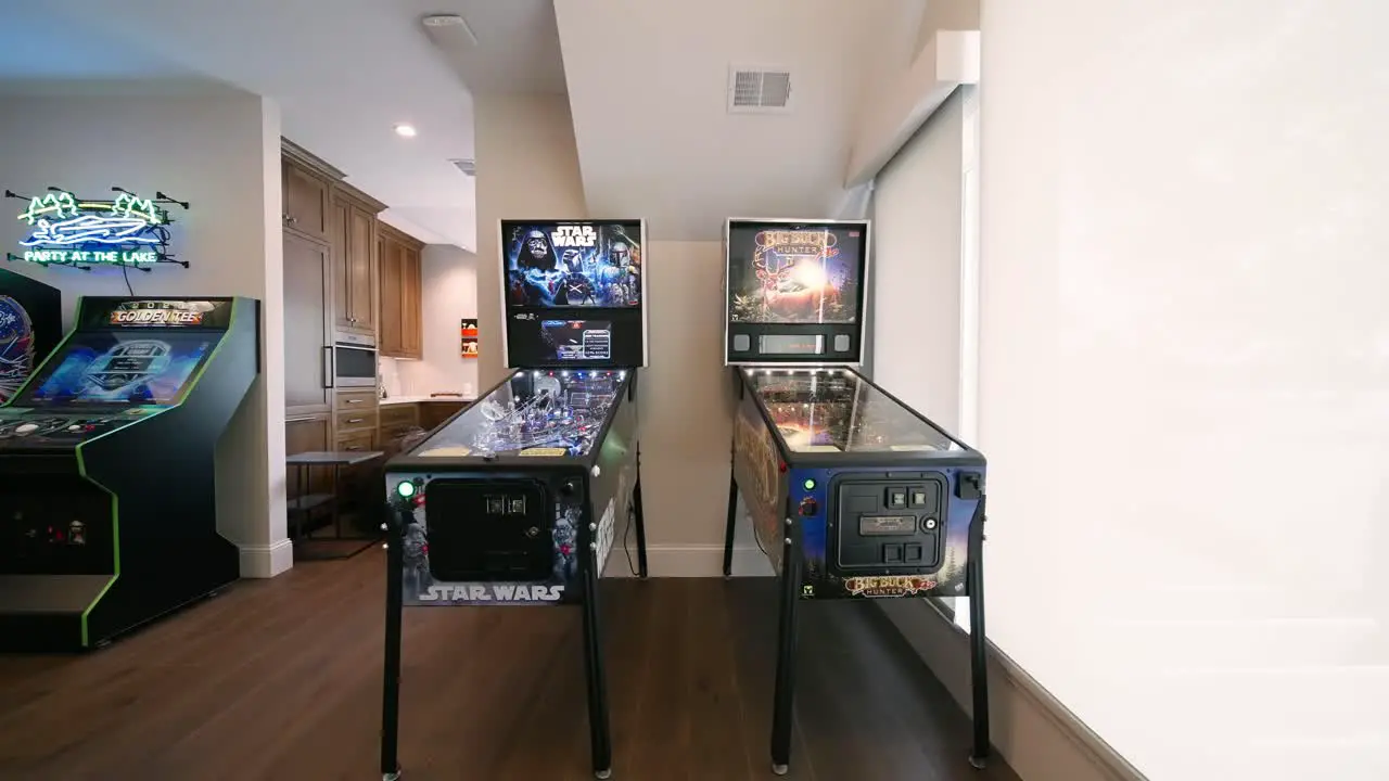 Side by side pinball machines in luxury home game room