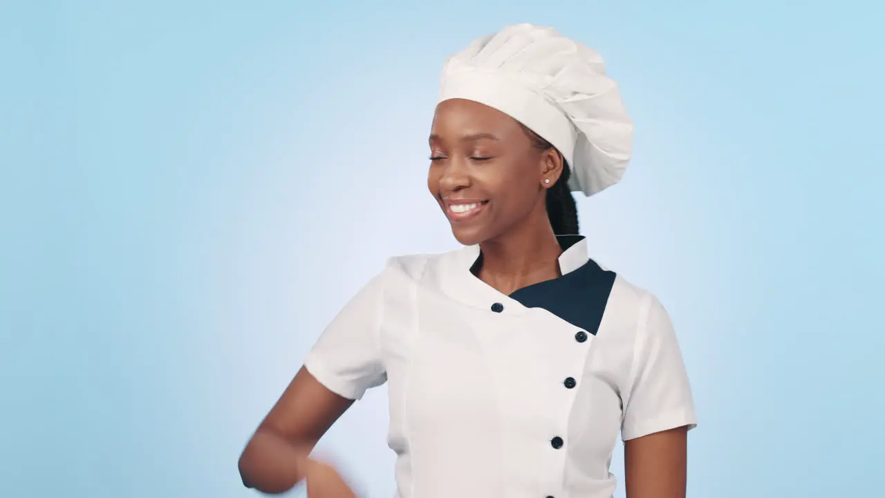 Chef happy black woman and point at palm gesture