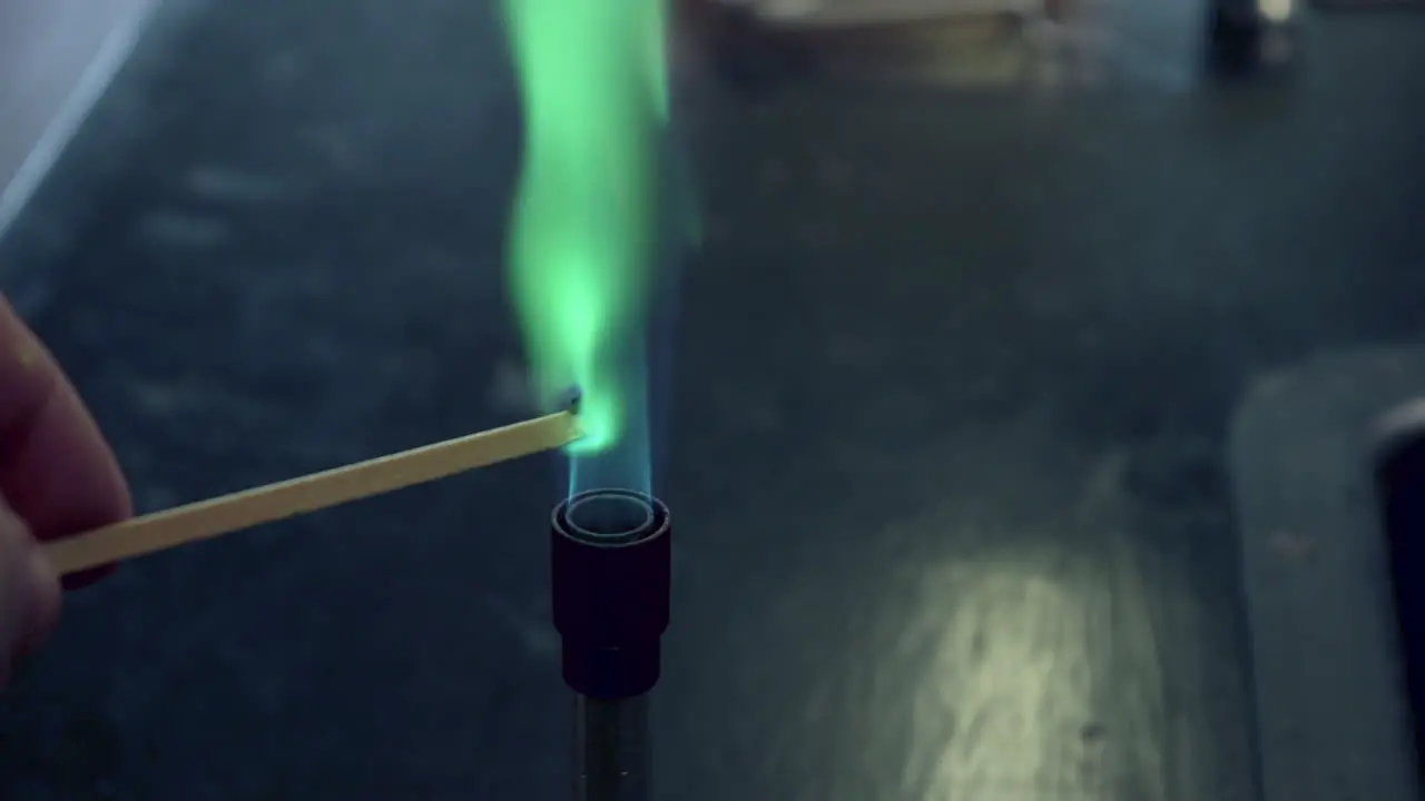 Close up of blue bunsen burner flame followed by copper flame test burning green