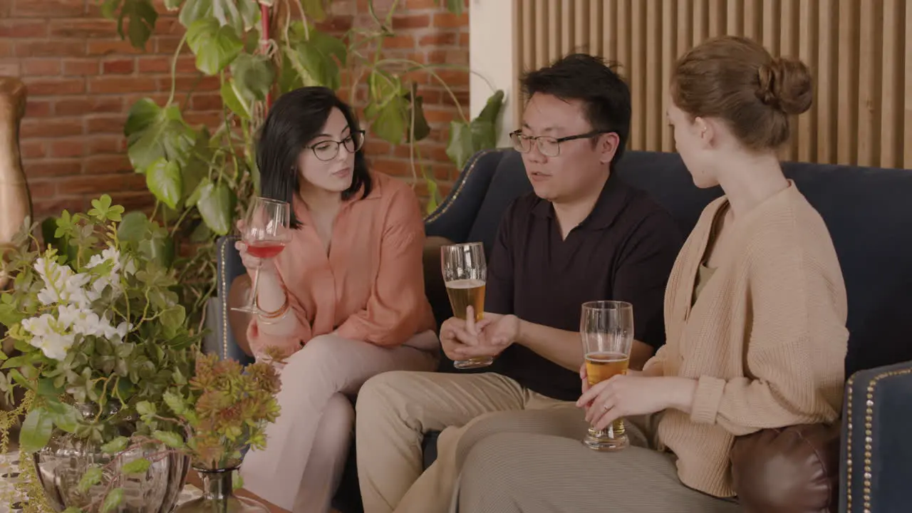 An Young Man Talking With Two Young Beautiful Girls