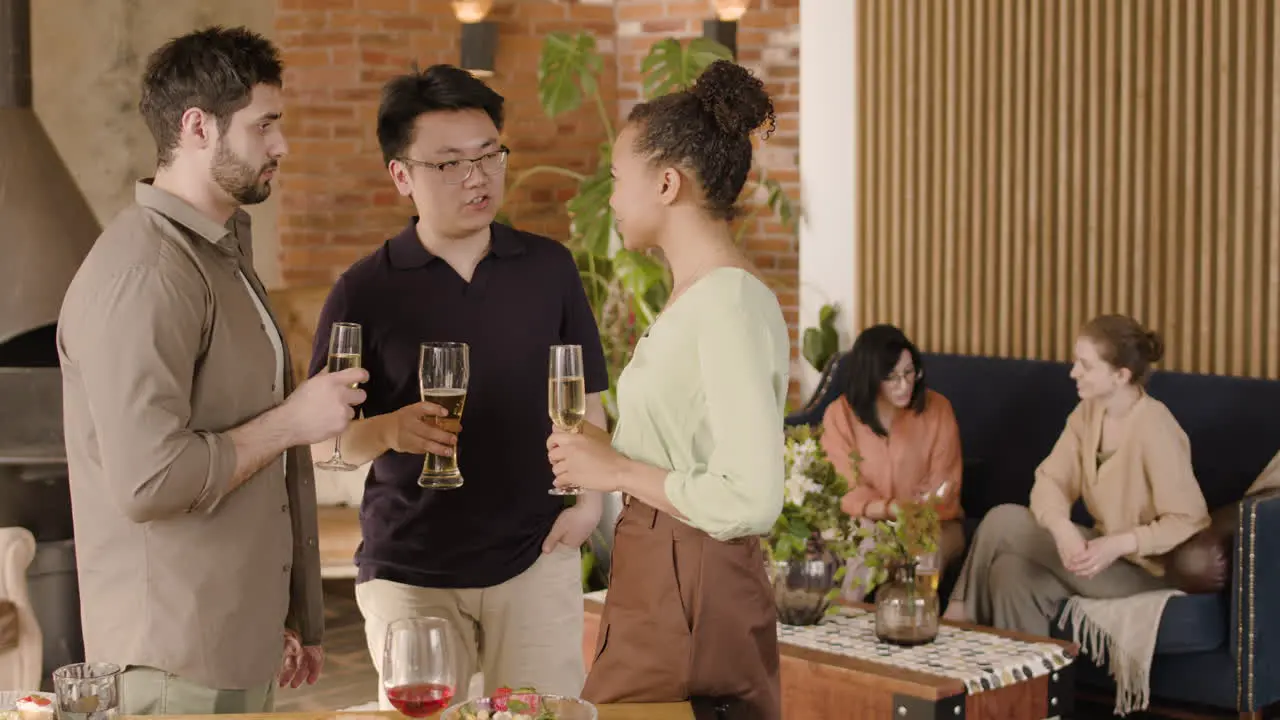 A Group Of Three Friends Talking At A Dinner Party