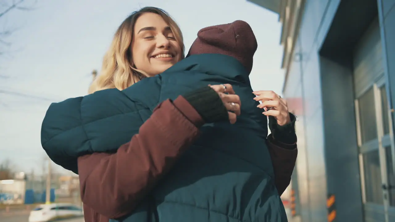 Female Friends Hugging And Talking In The City