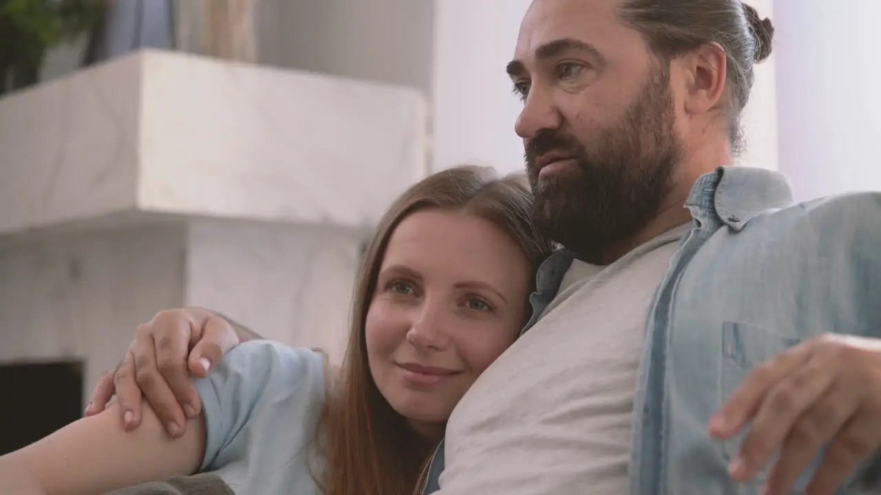 Bearded Man Converses With His Partner An Attractive Woman Who Rests Her Head On His Shoulder 1