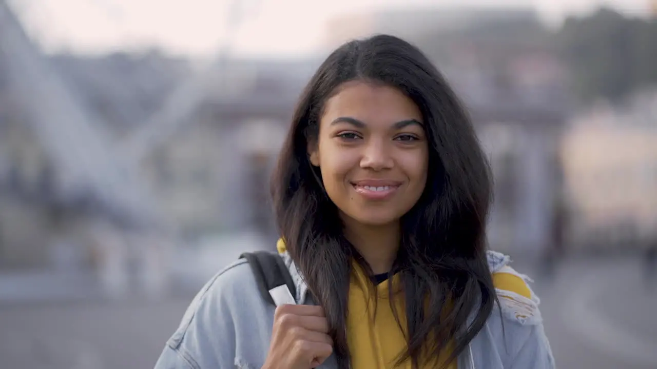 Portrait Of Young Pretty Black Woman Smiling And Looking At Camera Outdoors