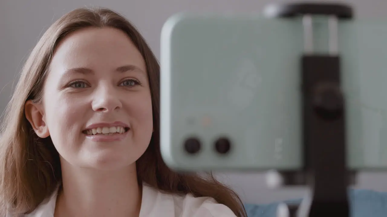 Close Up Of Beautiful Vlogger Girl Reviewing A Makeup Brush For The Camera