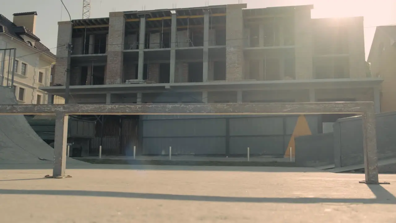 Skateboarder Girl Skating In A Skatepark In Front Of A House Under Construction