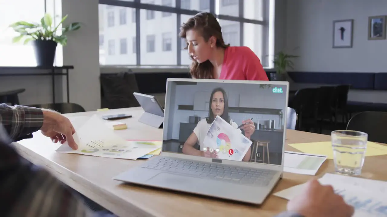 Caucasian businessman on laptop video call with african american fefmale colleague on screen