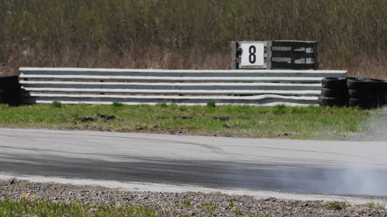 Drift car on a racing track passing by in slow motion