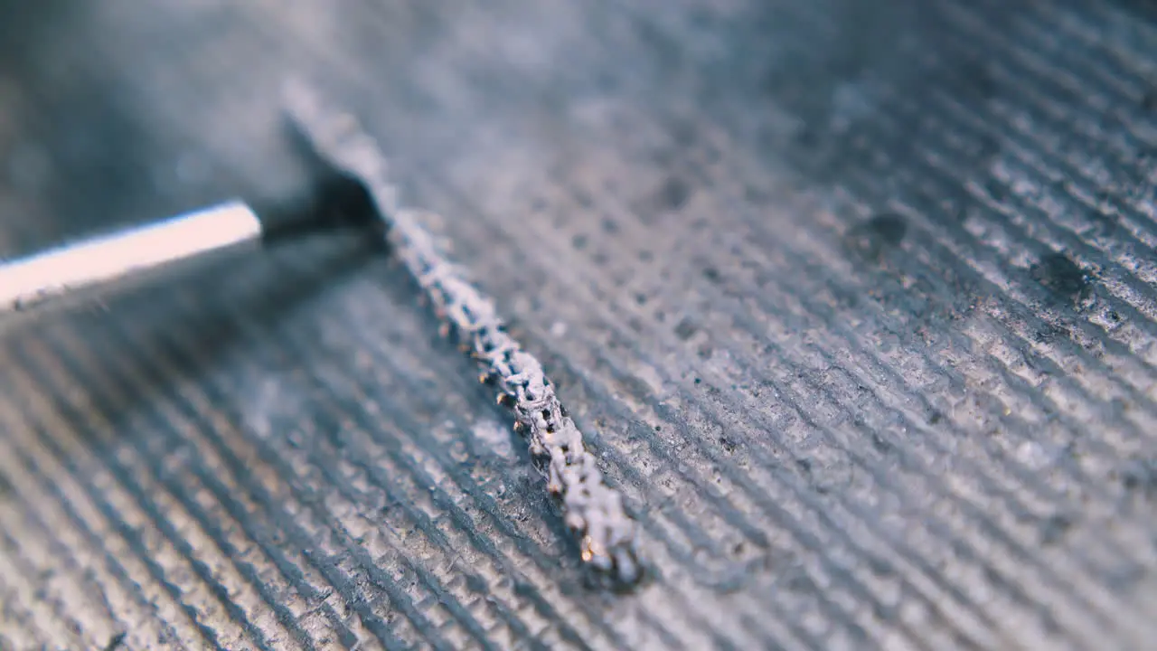 applying material onto heating chain on fireproof surface