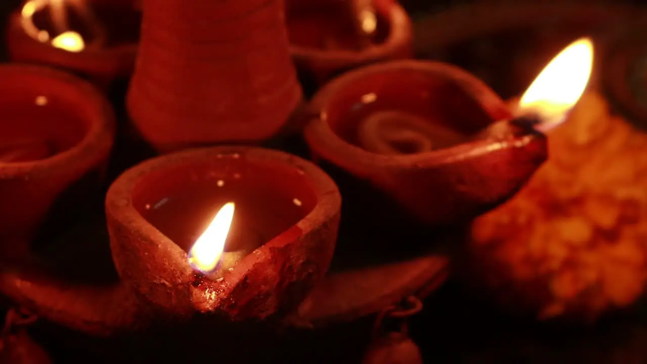 Close up video of a beautifully lighting a lamp flickering in the dark