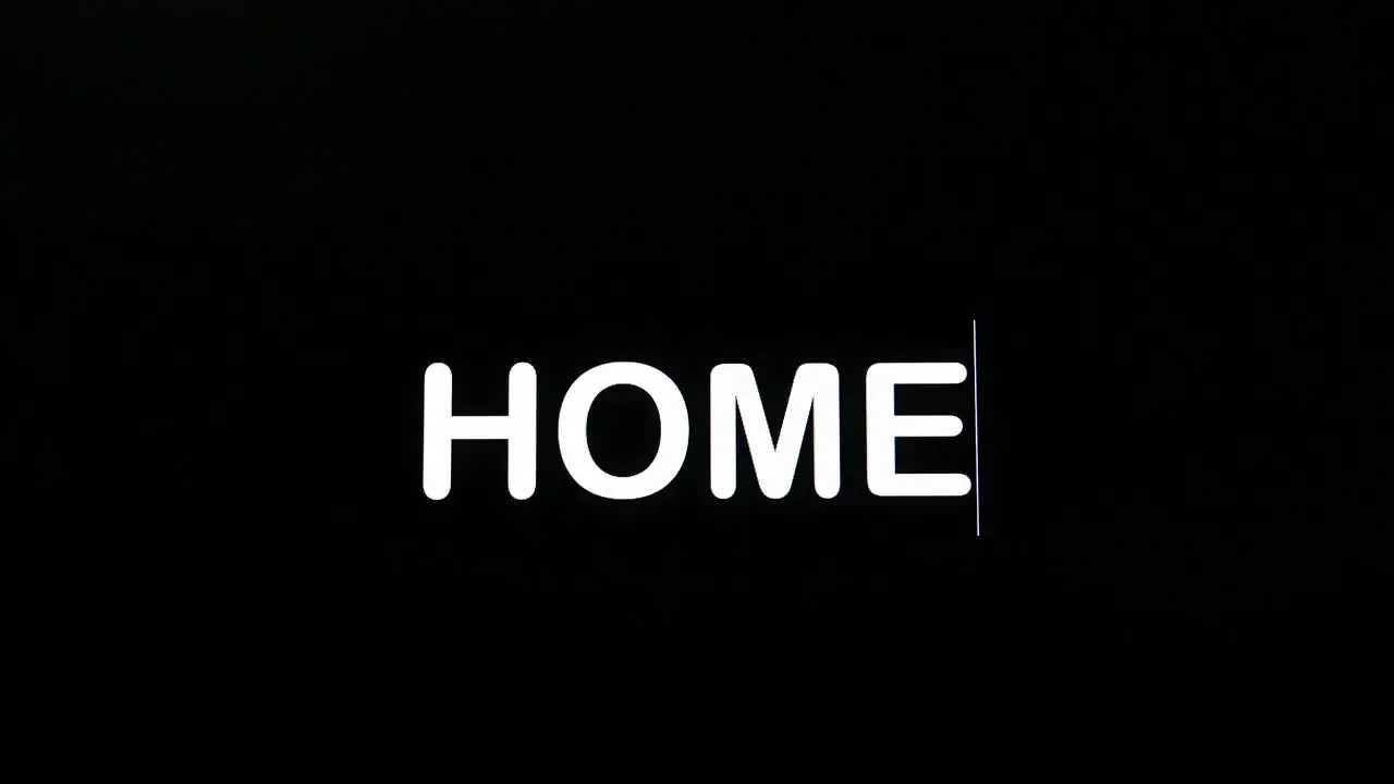 Detail of paragraph typing the word home on a dark background on screen