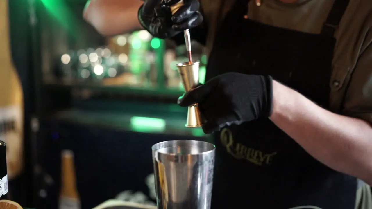 latin bartender mixing cocktail in slow motion liquid mixer