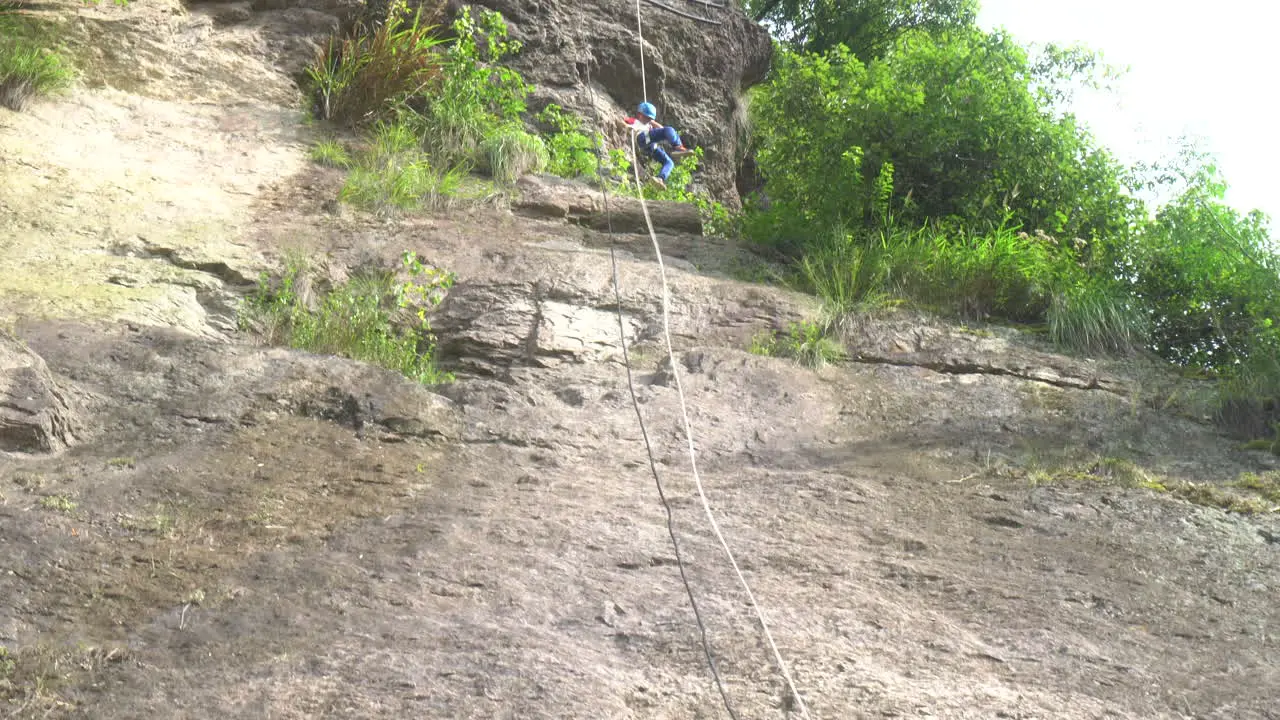 A child descending rapidly in mid air over a cliff