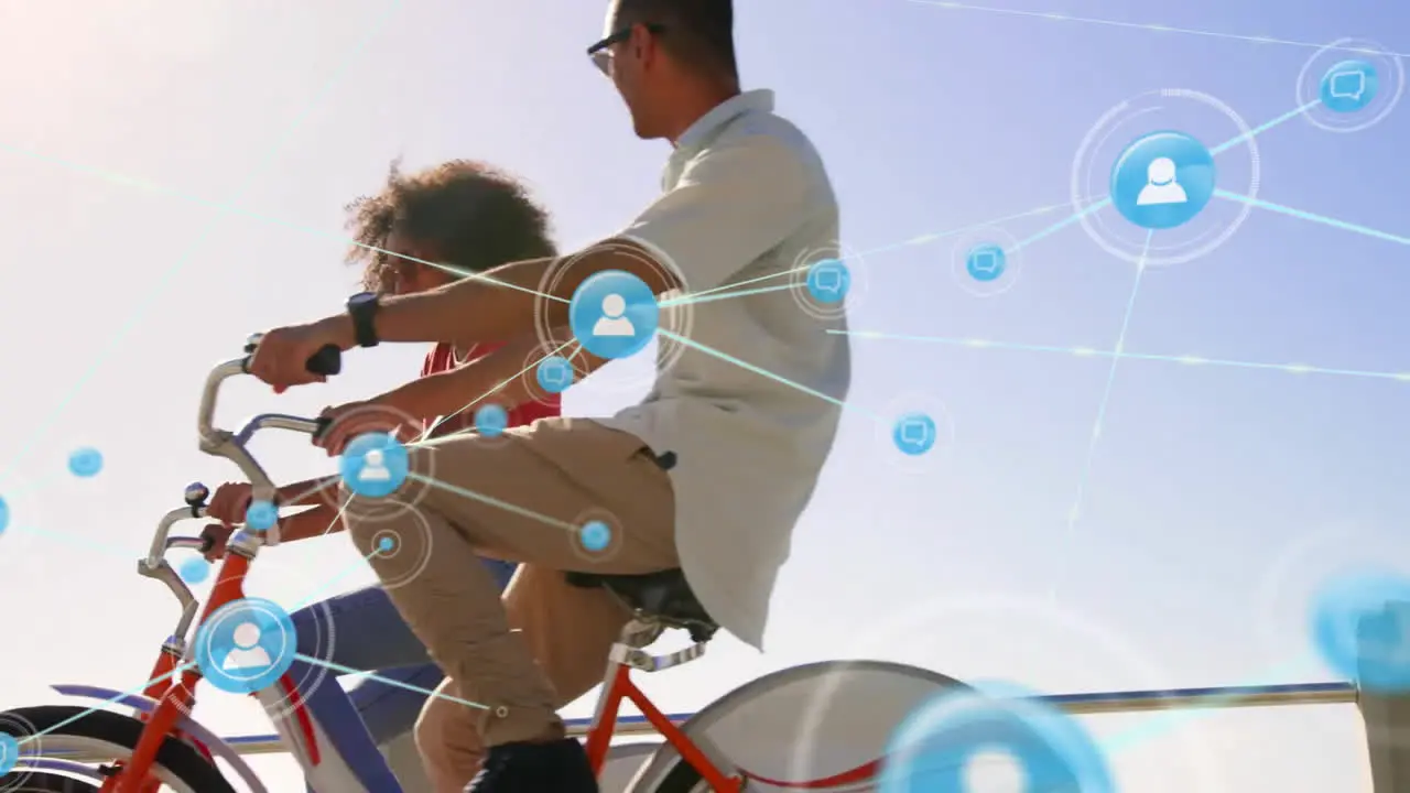 Animation of network of connections with icons over diverse couple on bikes by sea