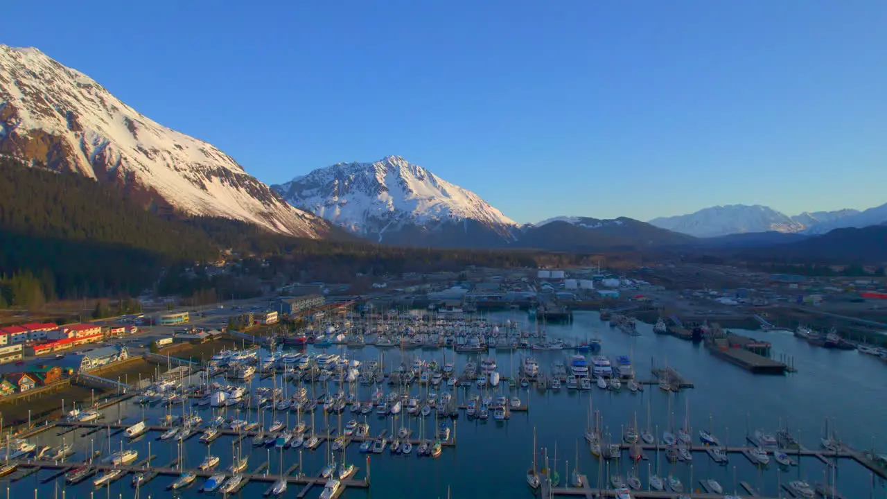 Rising up view of Seward Boat Harbor and mountains at sunrise in Seward Alaska