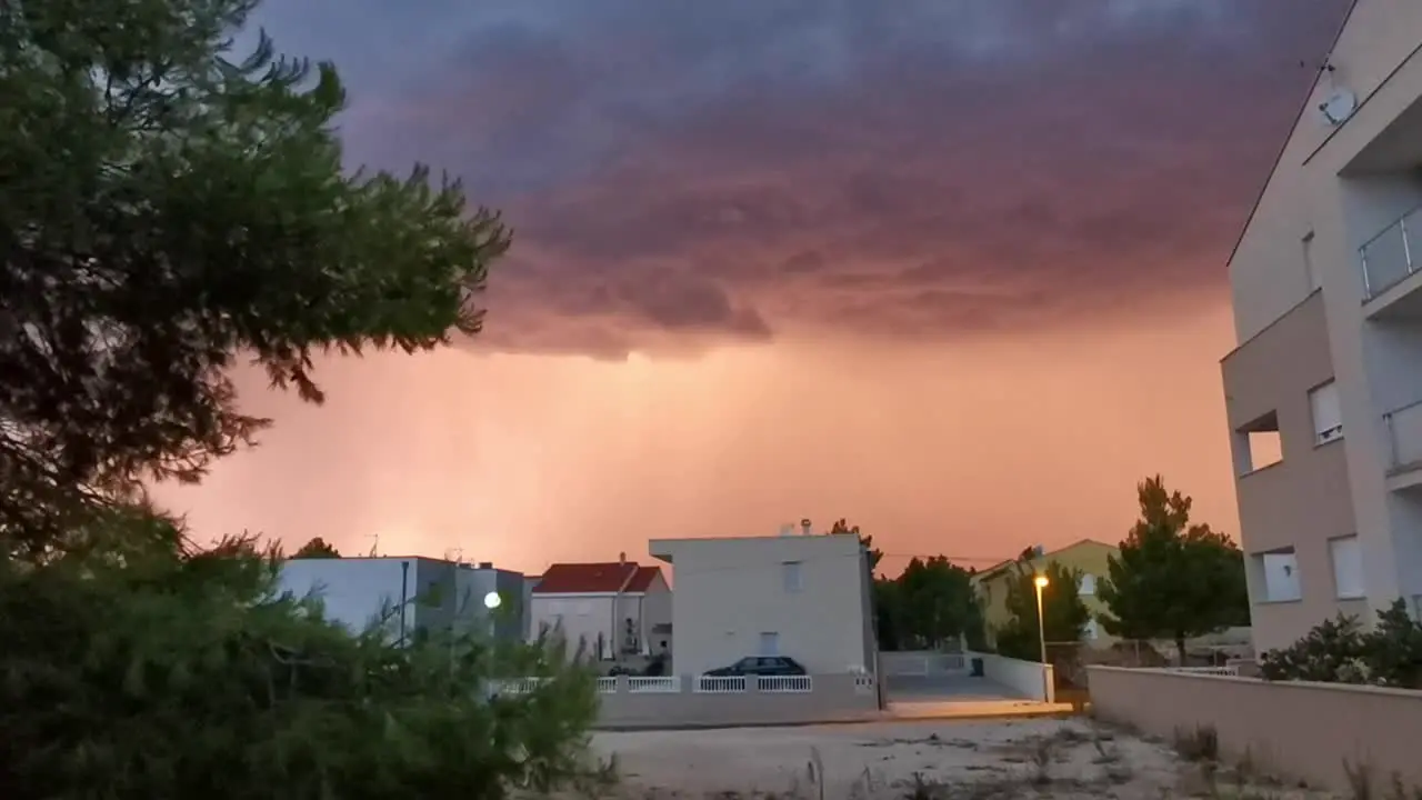 Colourful clouds of a sunset storm with lightning in an urban area in Croatia