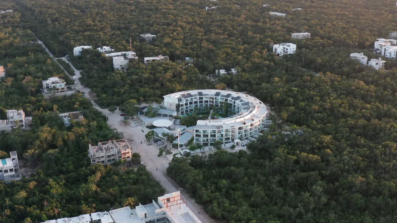 Counter clockwise orbiting shot of white building in Tulum Mexico during sunset