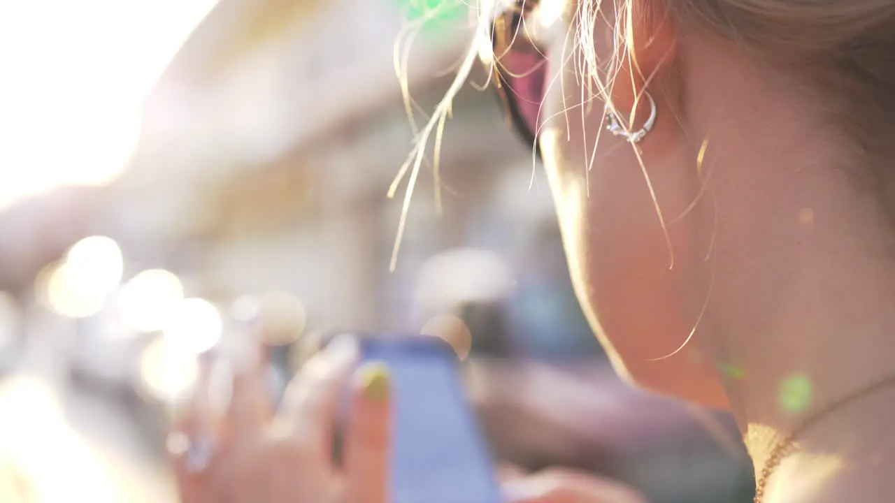 Woman surfing internet on mobile in city street