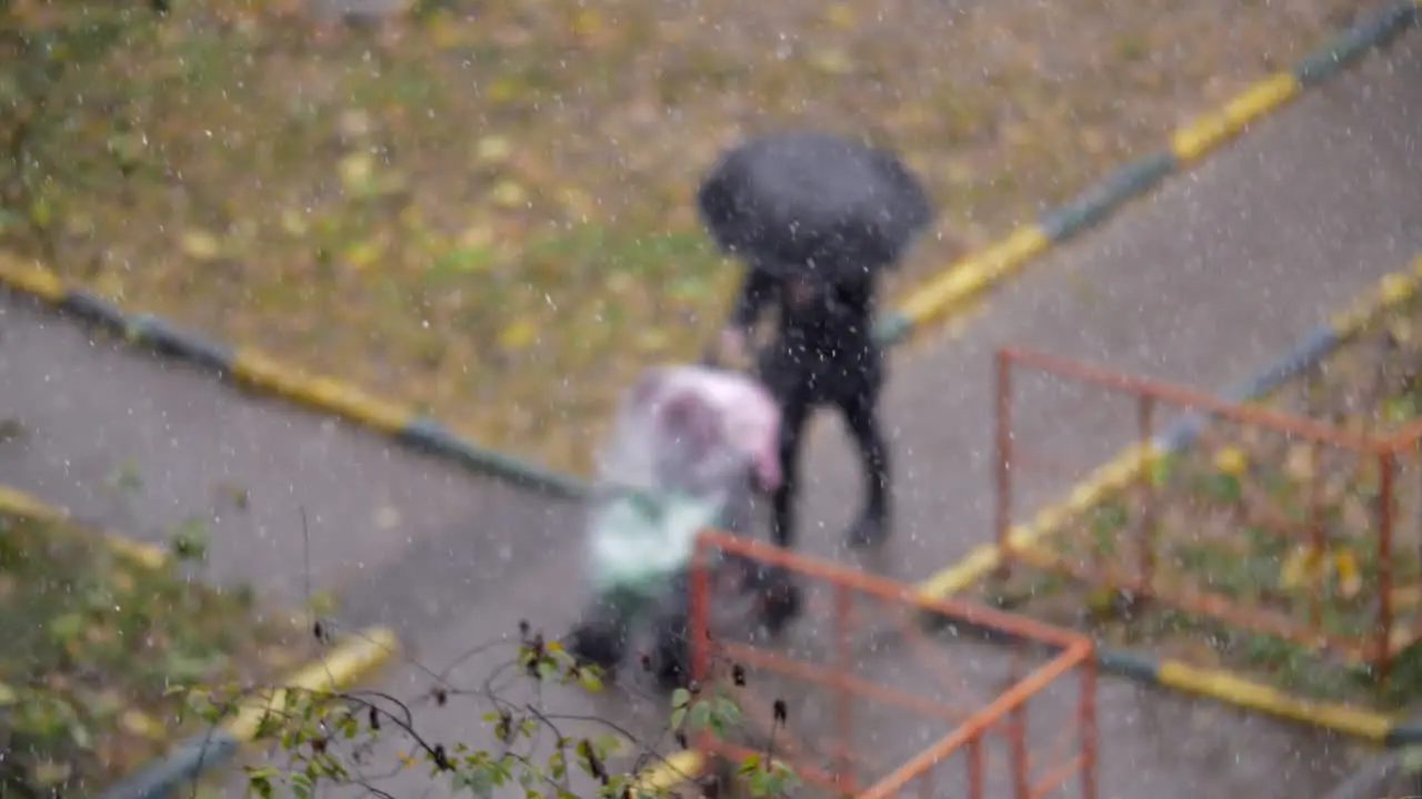 Woman with child outside on snowy autumn day