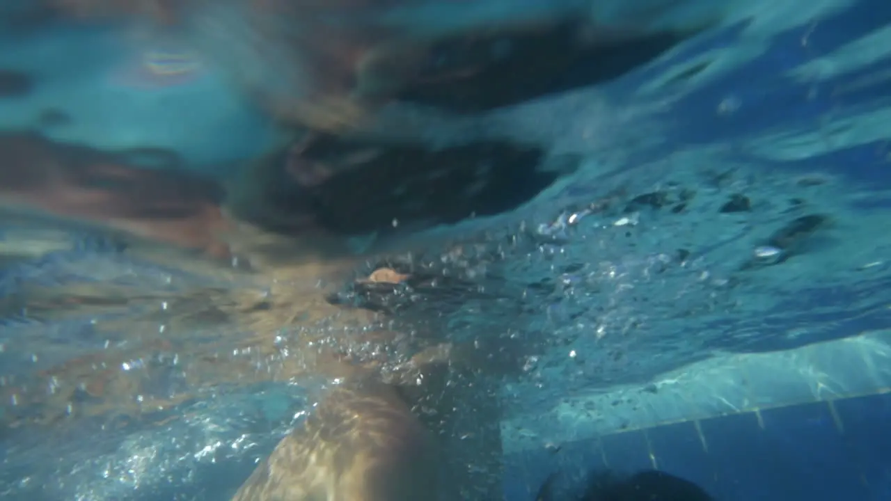 Father and son playing in the swimming pool