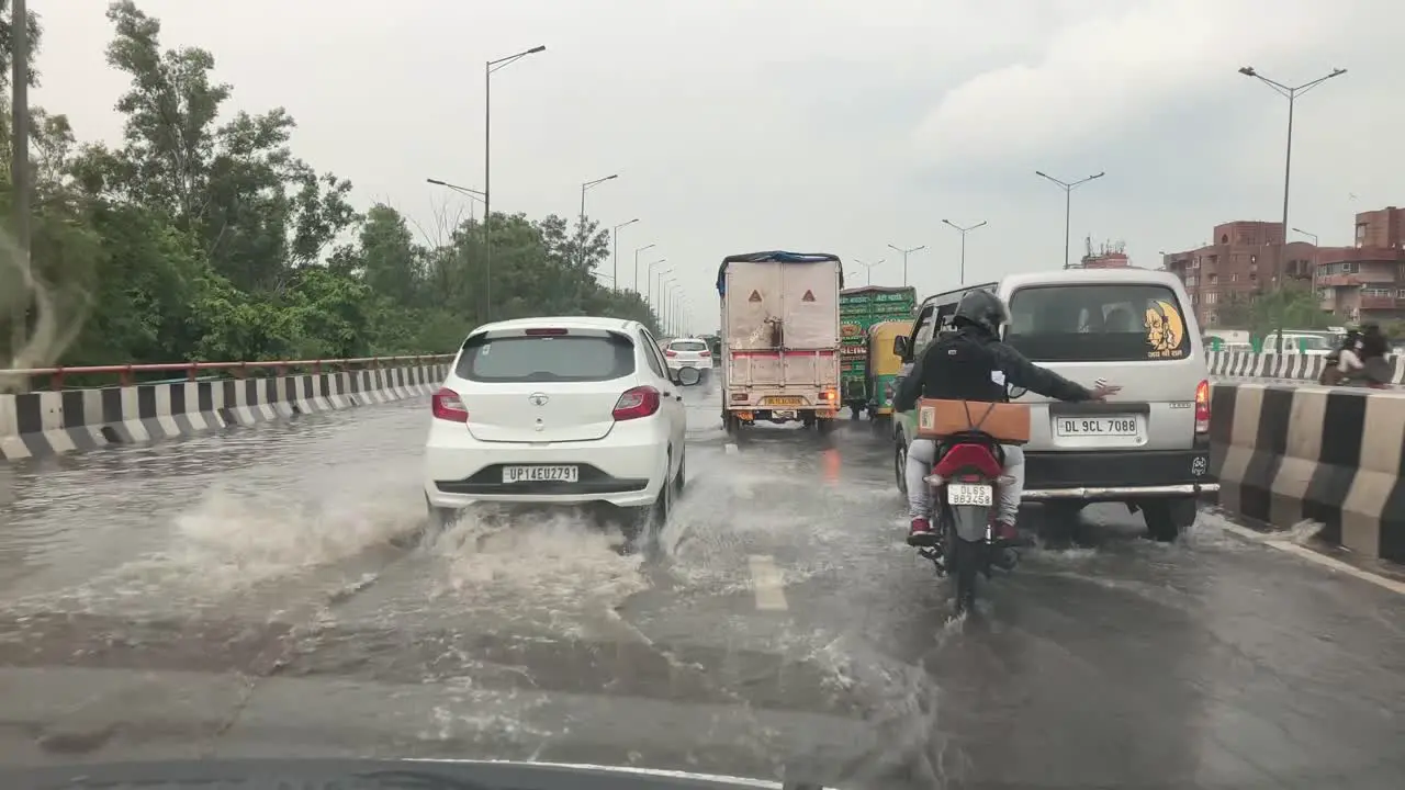 Car splashes water by speeding up during rain