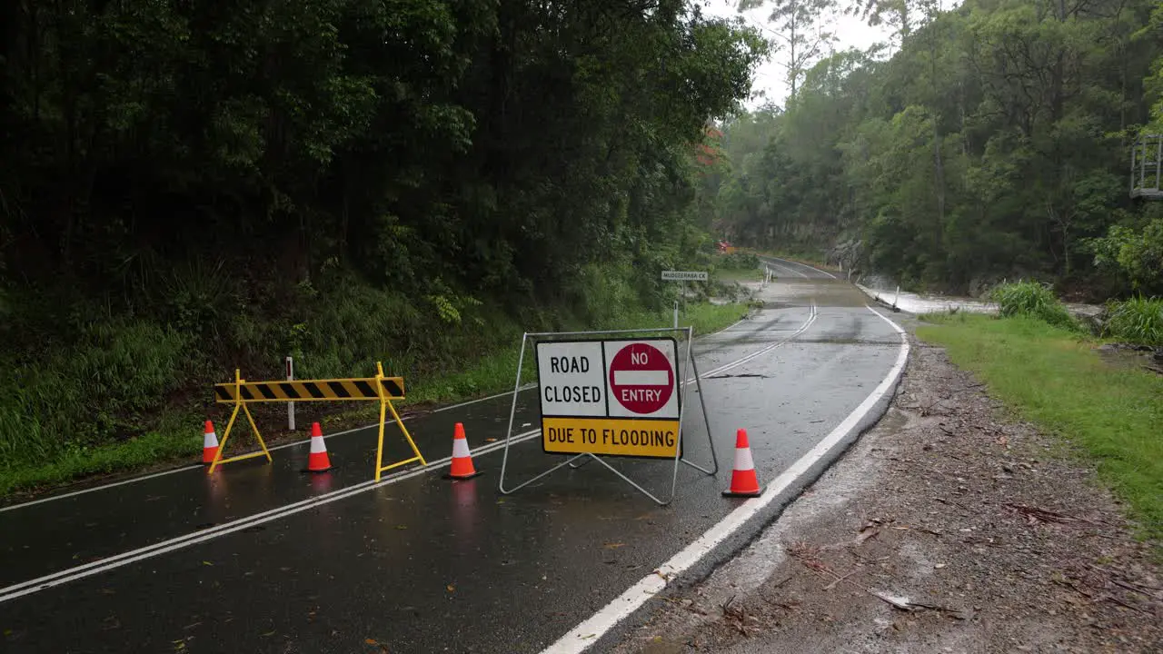 Mudgeeraba Gold Coast 02 January 2024 Wide shot of flooding across Mudgeeraba Creek Bridge causing road closure