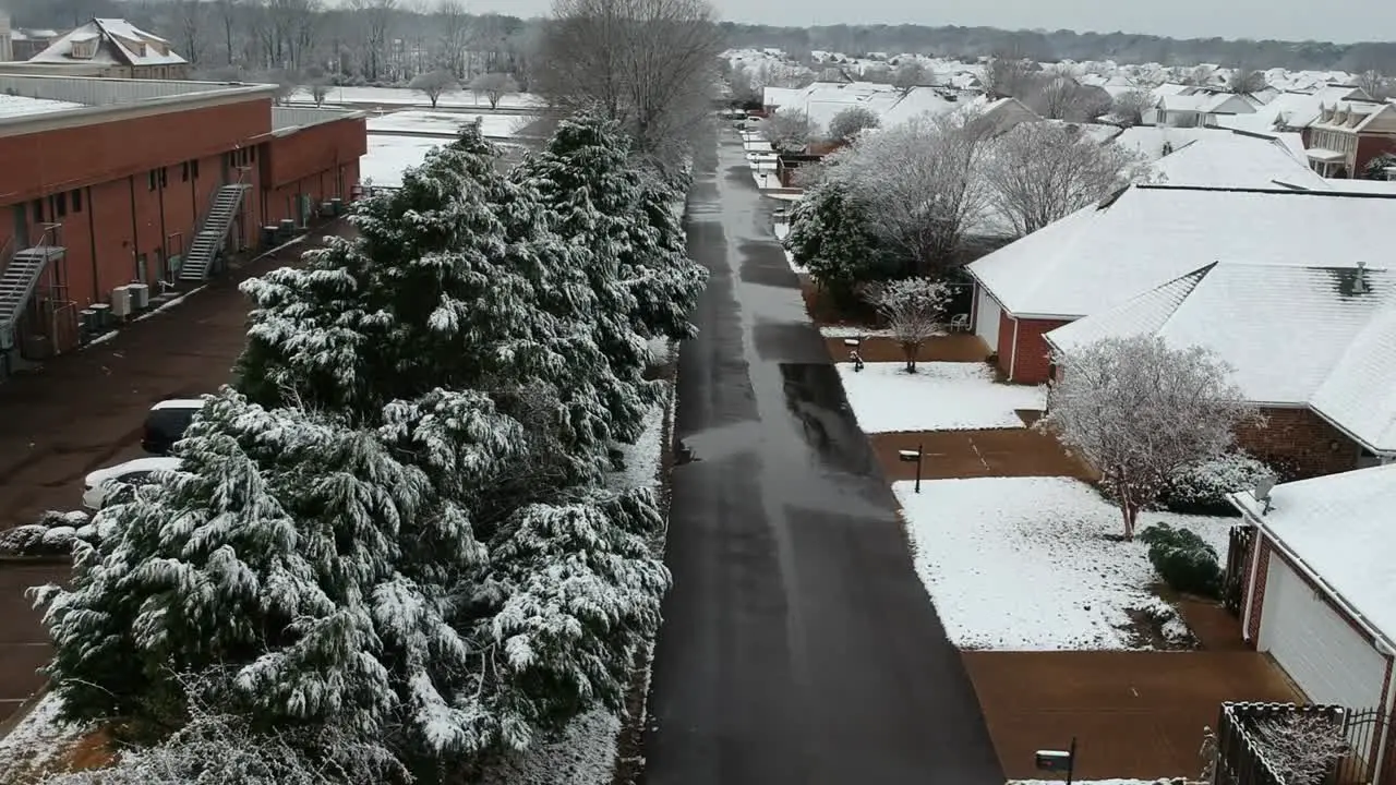 Drone flies over neighborhood covered in snow