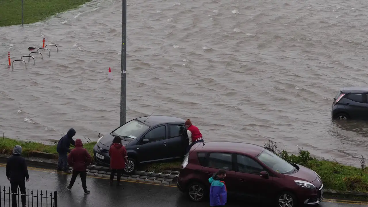 Neighbors unite during rough Irish weather to rescue cars from floods