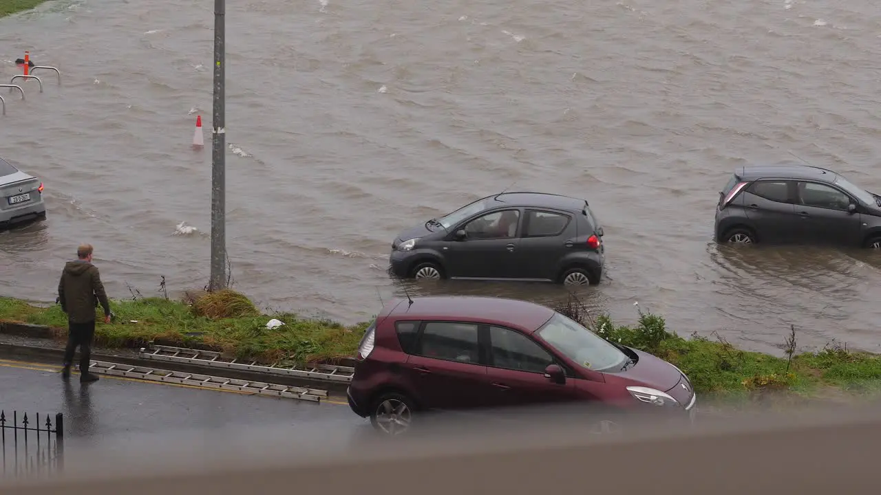 Small car reversing trying to get out of flooded carpark