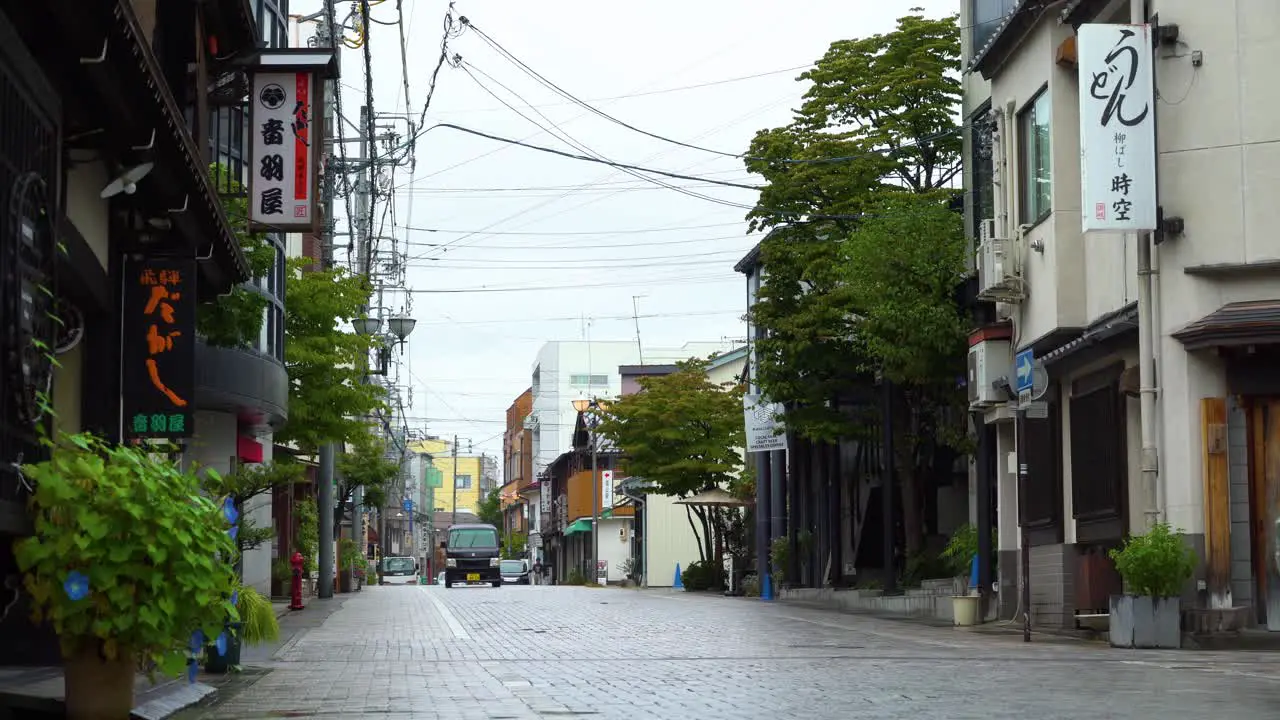 A van drives down an otherwise empty street in Tokyo Japan