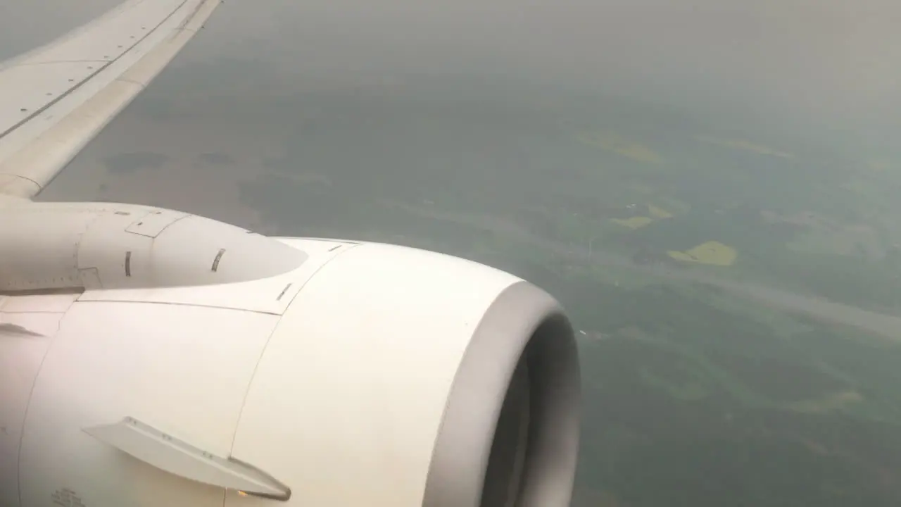 The passenger airplane engine in the air wide shot tiltion slowmo