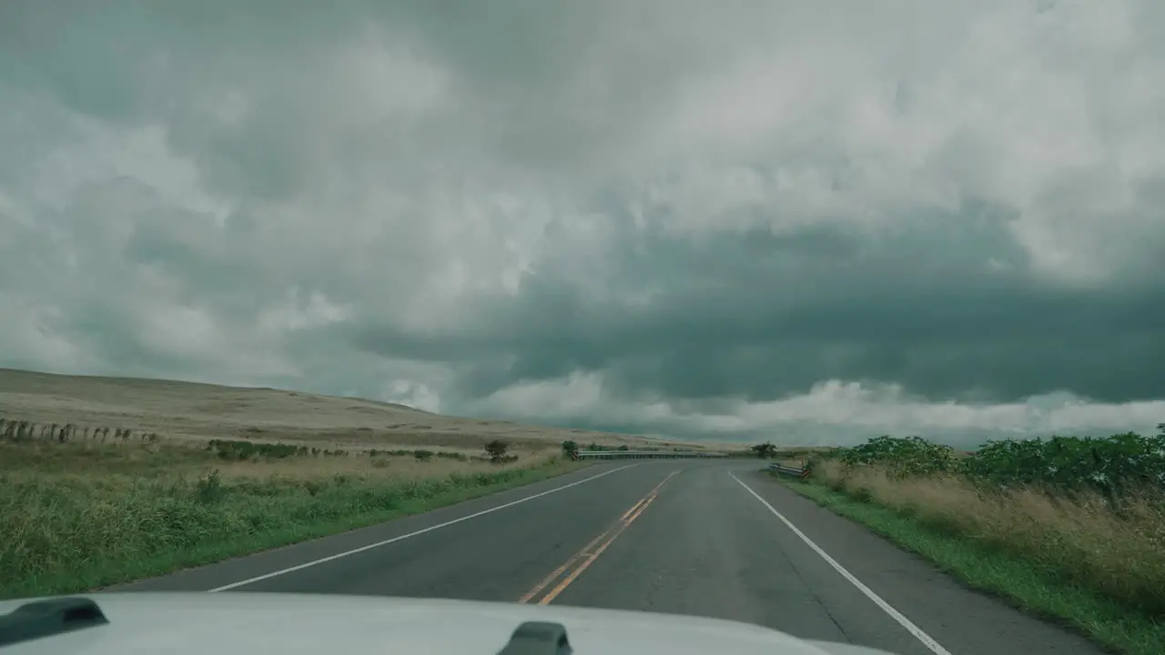 Point of view of a car driving on a hawaiian road in cloudy weather