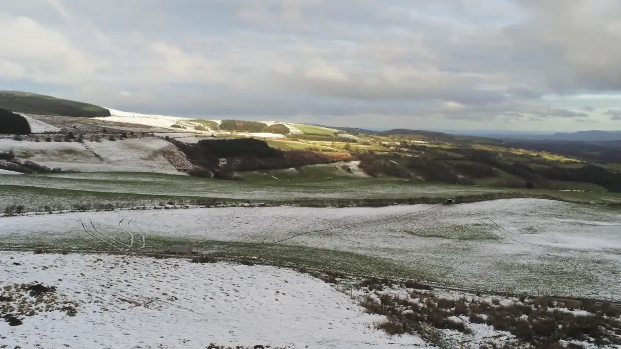 Snowy idyllic rural winter valley countryside aerial agricultural farmland landscape