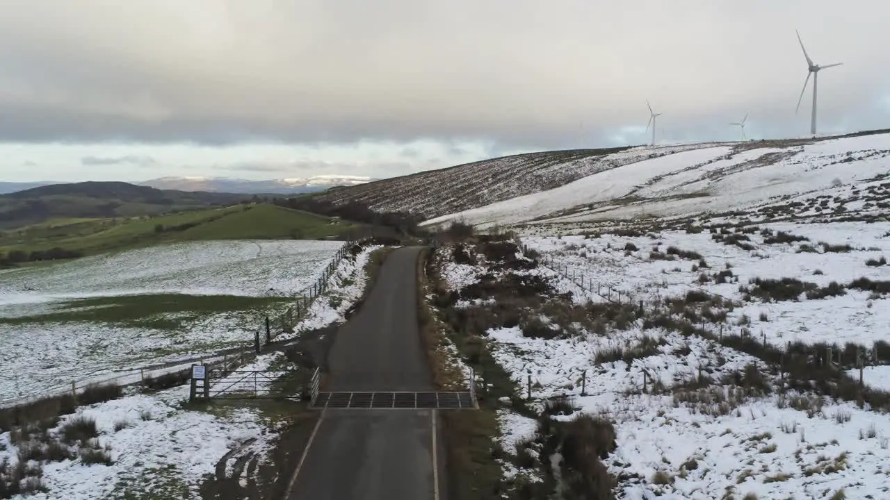 Snowy rural winter valley countryside aerial agricultural farmland landscape picturesque low flyover