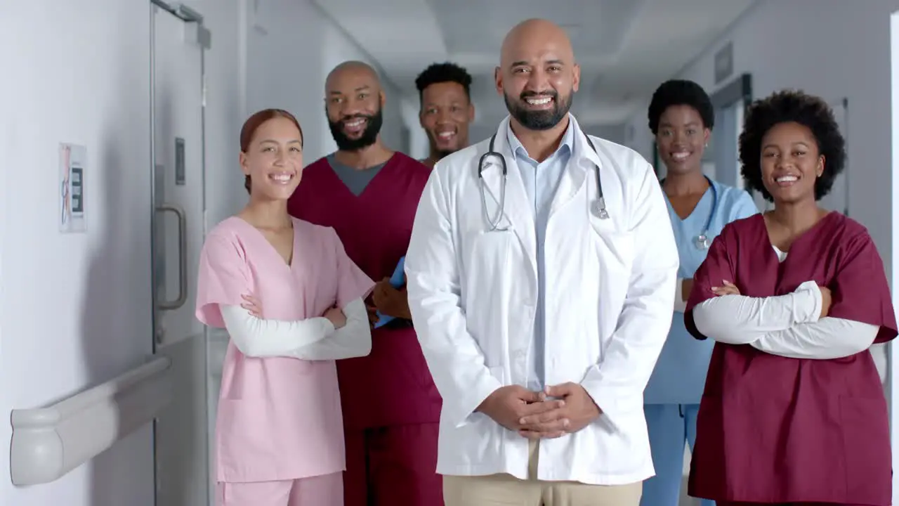 Happy diverse doctor smiling in hospital corridor slow motion