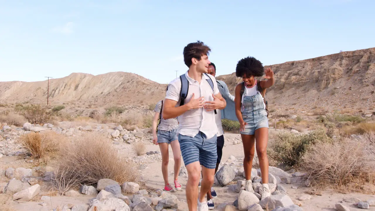 Five young adults hiking in Palm Springs desert front view