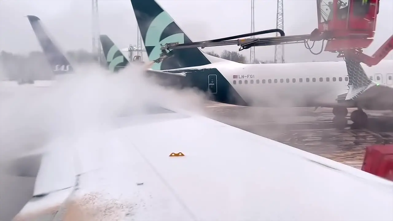 De-icing an airplane wing for a winter flight in Scandinavia